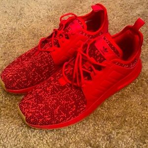 Red adidas running shoes